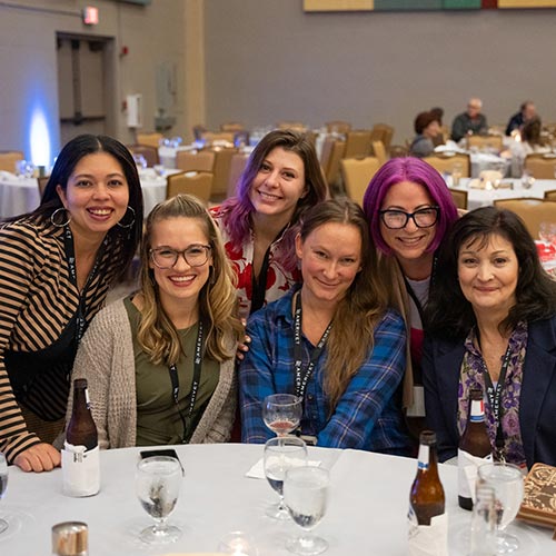 group posing and smiling during dinner at the AmeriVet summit